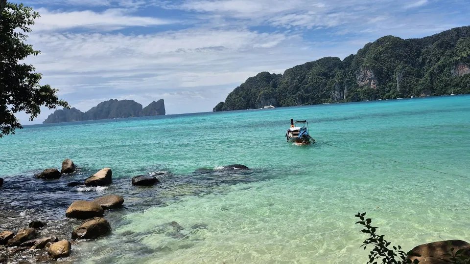 Long-tail boat anchored off a Thai island beach